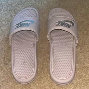 This is a pair of Nike slides. Soft pink color, great for summer.